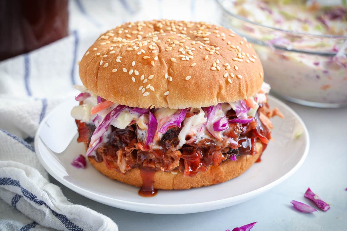 Smoked Pulled Pork on a sesame seed bun with coleslaw.