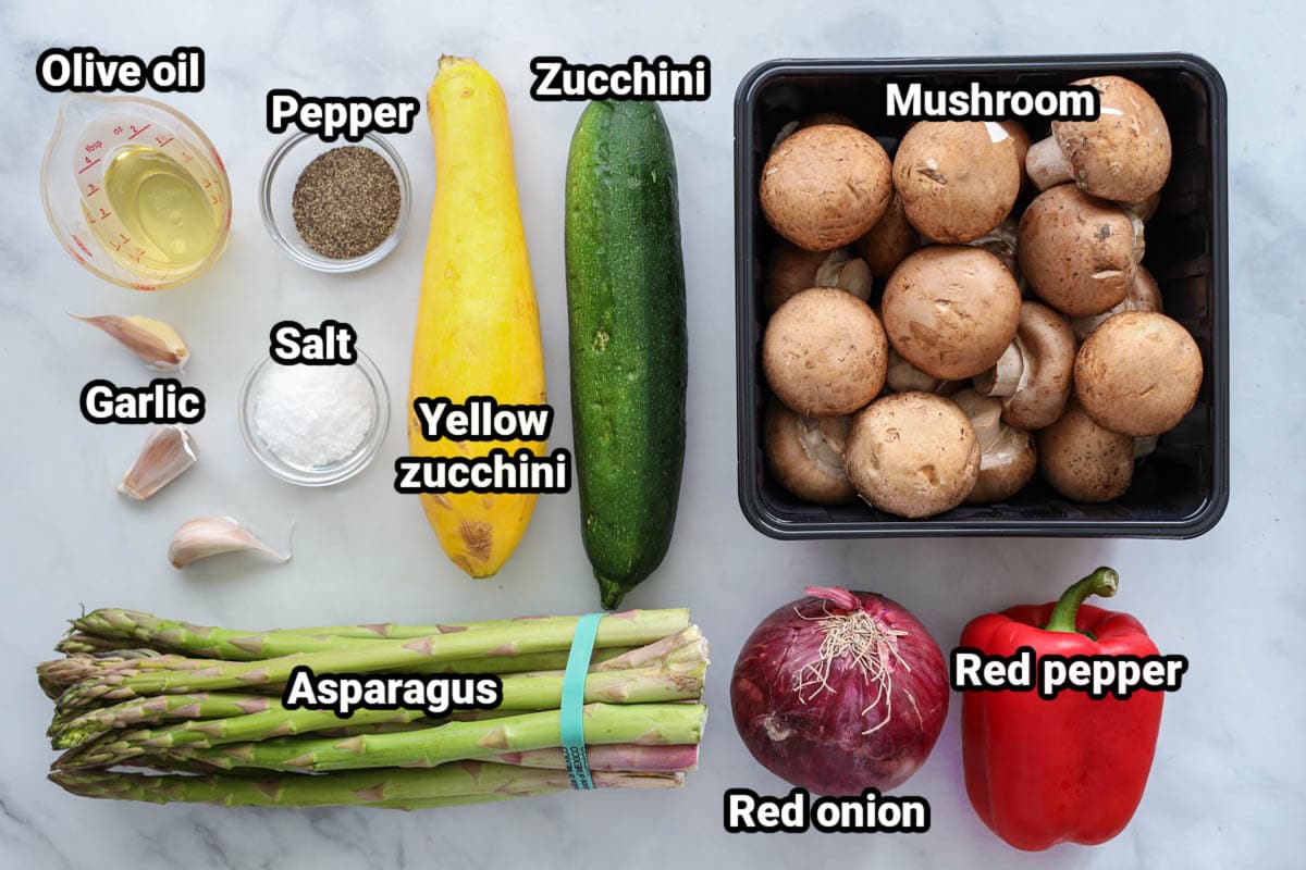 Ingredients for Grilled Vegetables: olive oil, salt, black pepper, garlic cloves, zucchini, yellow squash, mushrooms, asparagus, red pepper, and red onion.