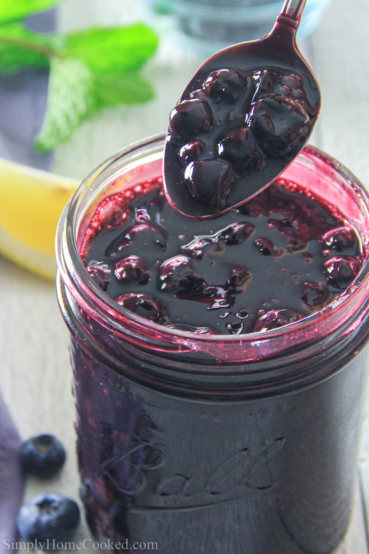 Spoonful of Blueberry Pie Filling in a jar.