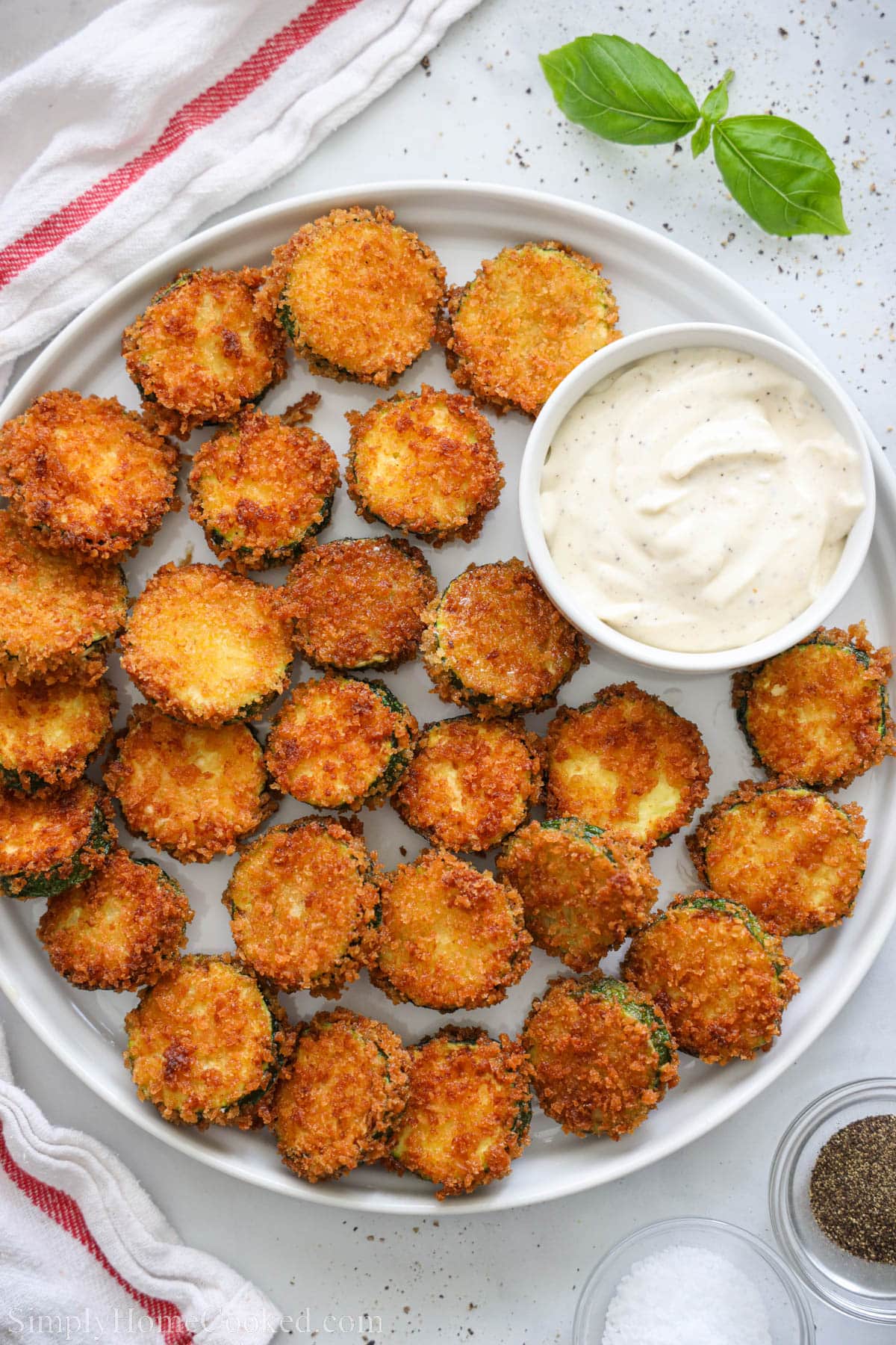 Fried Zucchini on a plate with garlic aioli sauce.