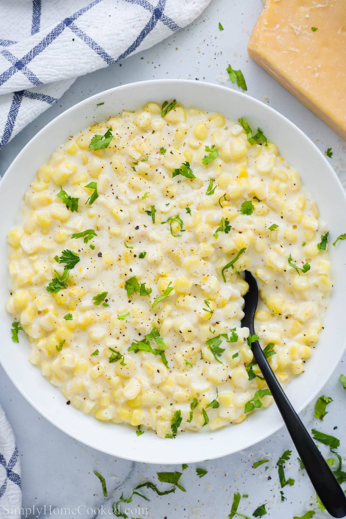 Overview of Creamed Corn garnished with parsley.