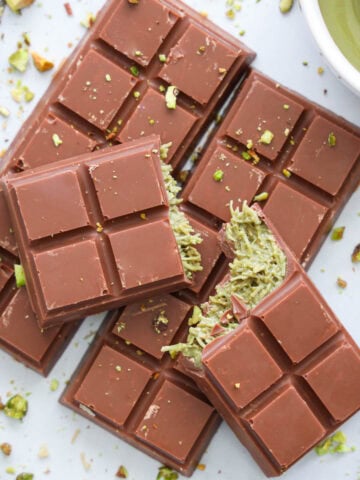 Pistachio Chocolate Bars with one broken on top.