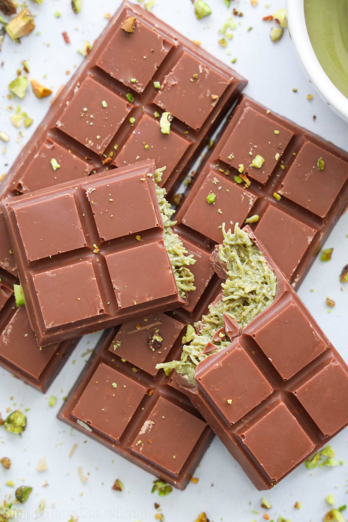 Pistachio Chocolate Bars with one broken on top.