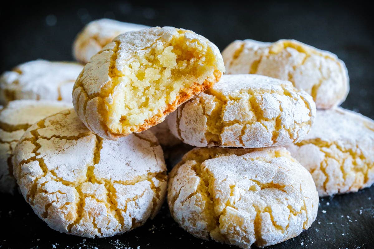 Pile of Amaretti Cookies, the top one missing a bite. 
