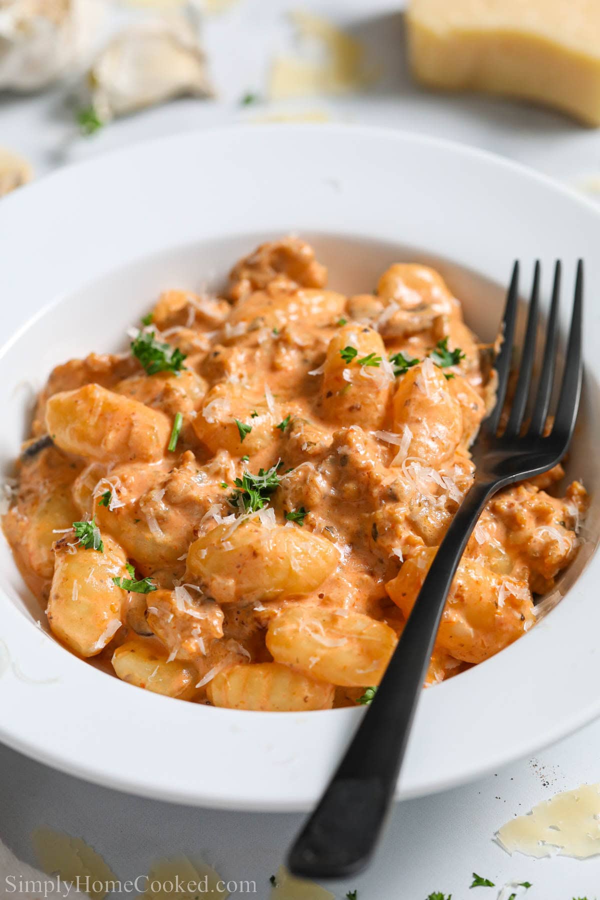 Creamy Sausage Gnocchi in a bowl with a fork.
