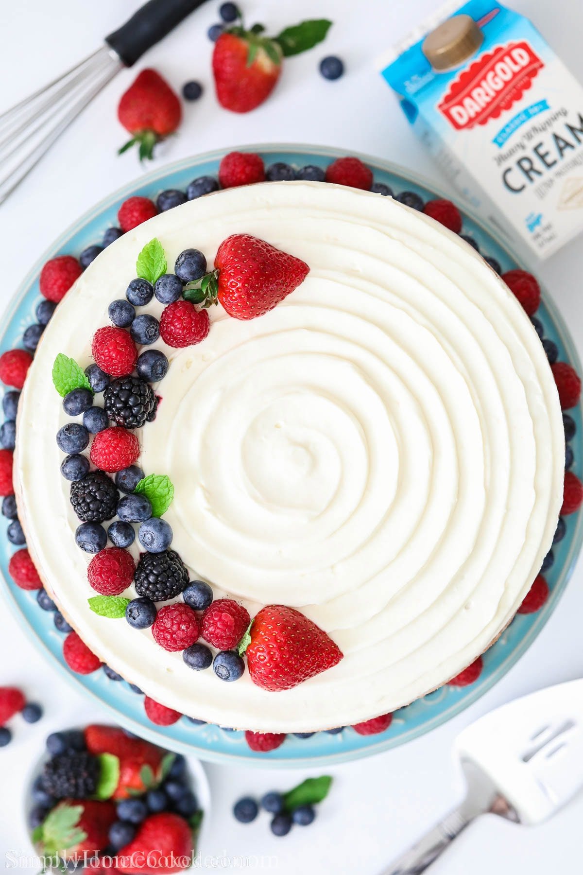 Overview of Berry Chantilly Cream topped with fresh berries.