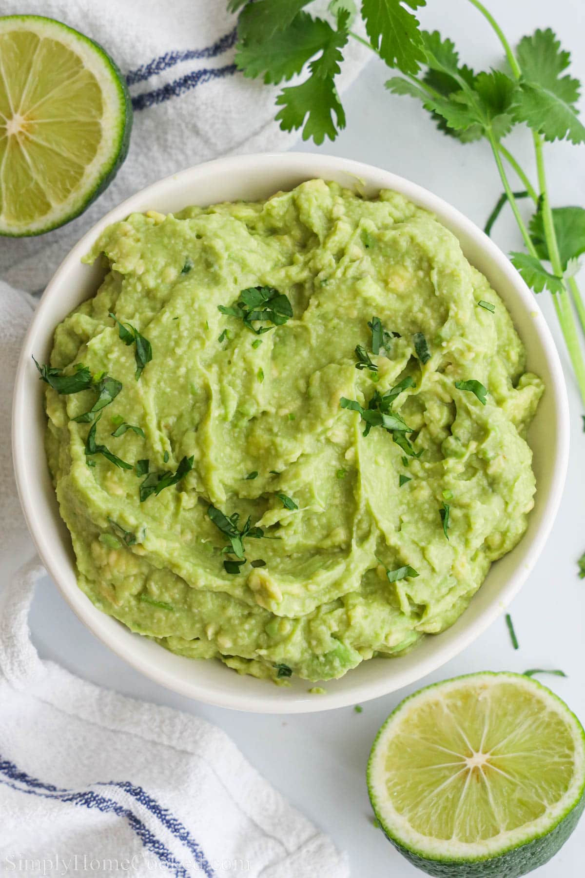 An overview of Easy Guacamole ina bowl, topped with chopped cilantro.