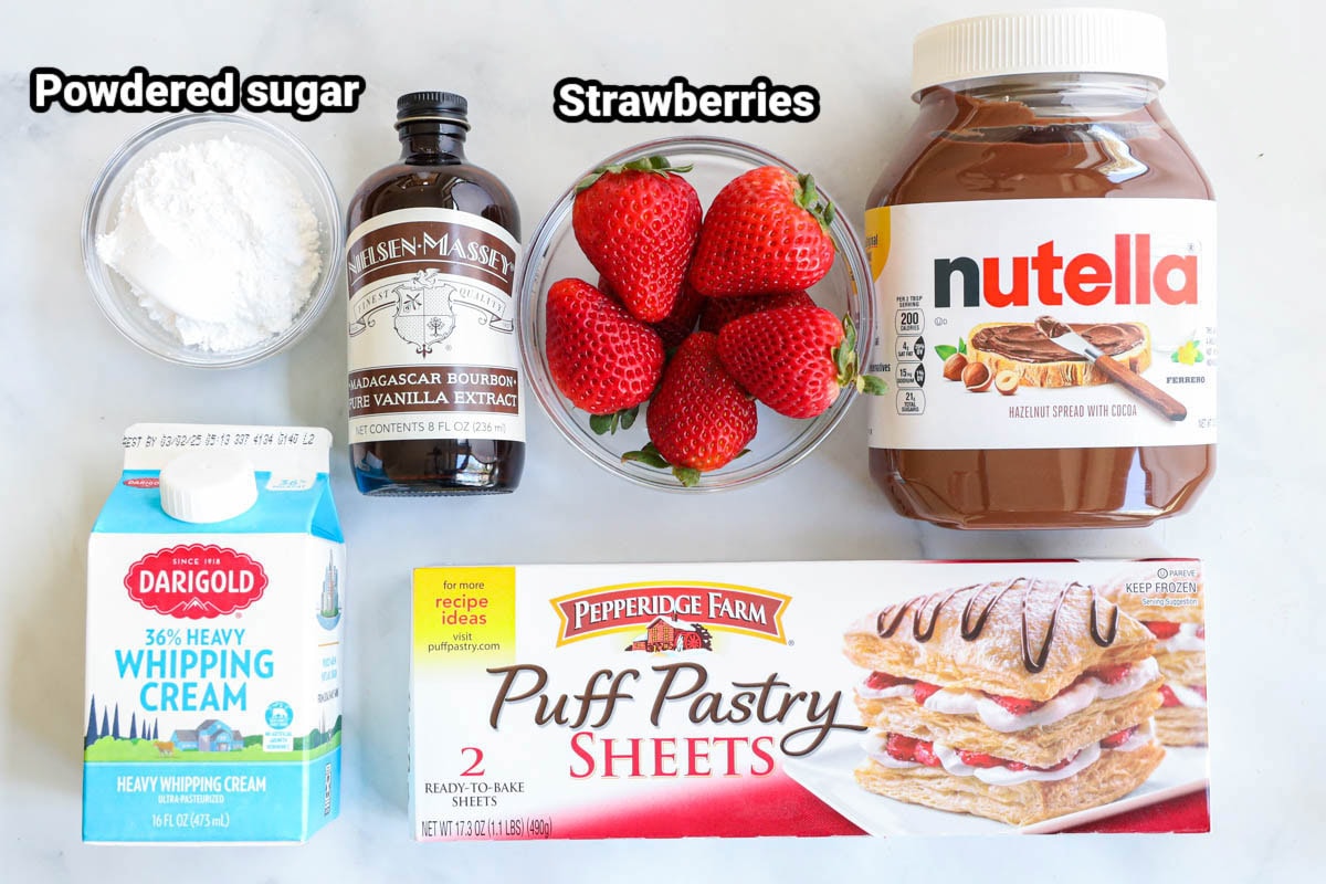 Ingredients for Strawberry Nutella Puff Pastry: powdered sugar, vanilla, strawberries, Nutella, whipped cream, and puff pastry sheets.