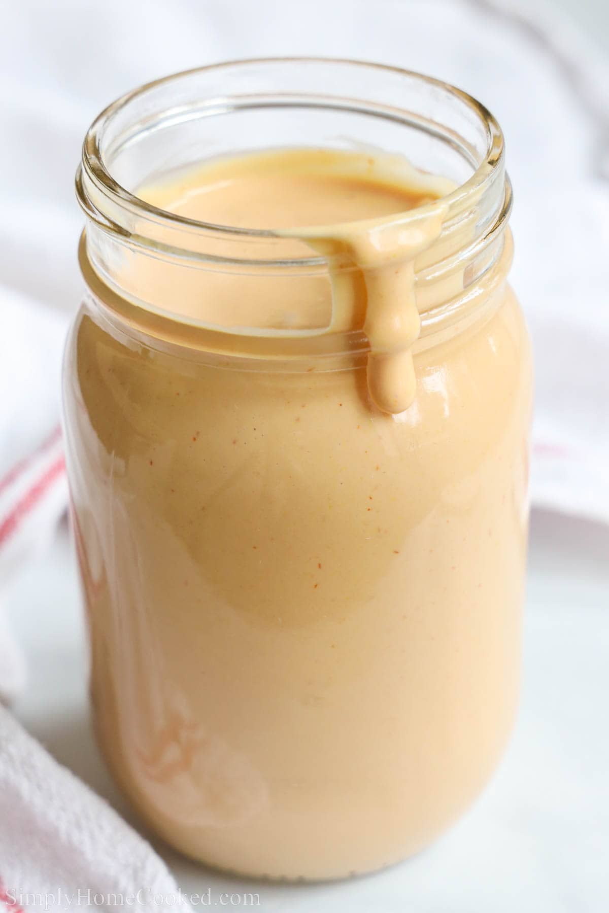 A mason jar full of Burger Sauce.