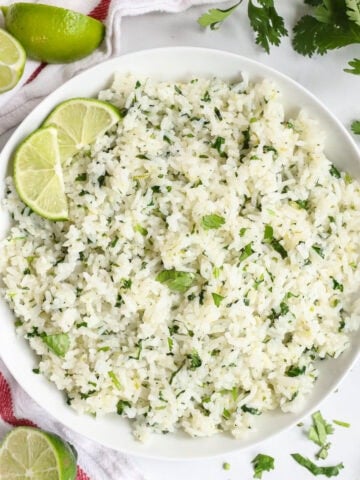 Cilantro Lime Rice in a bowl with lime slices.