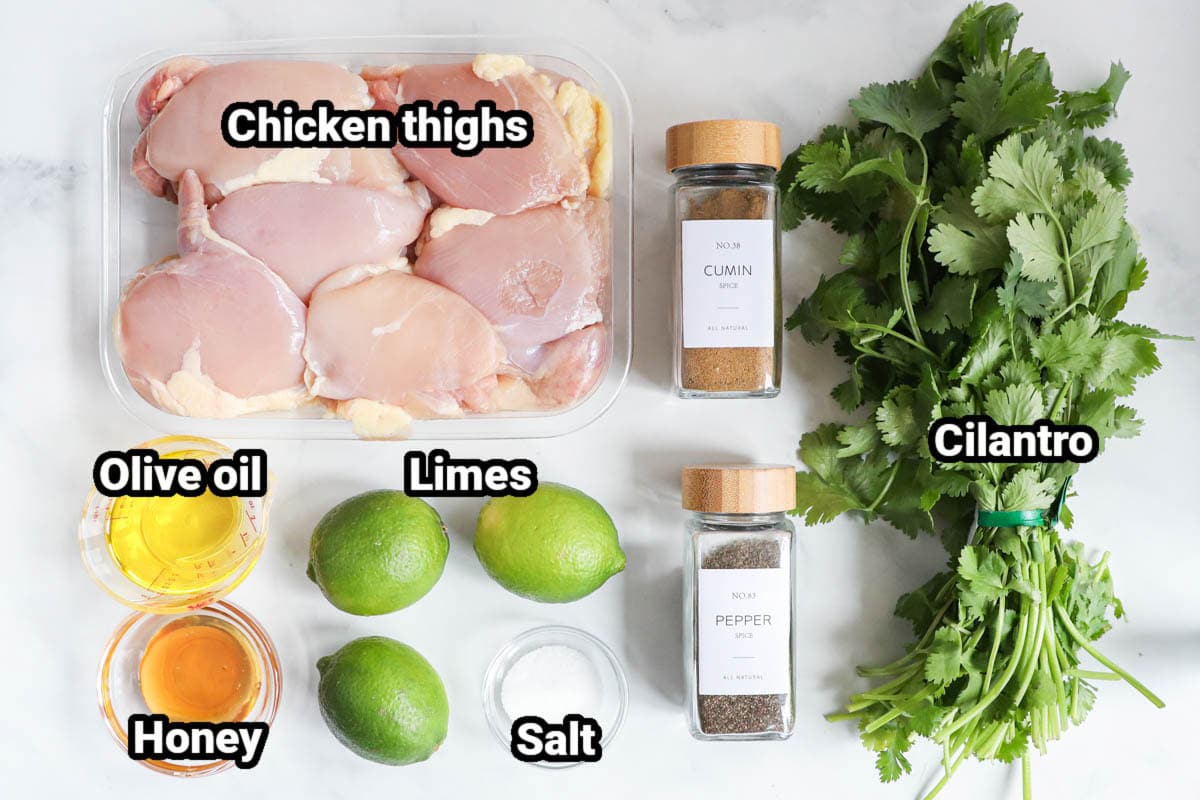 Ingredients for Cilantro Lime Chicken: chicken thighs, cilantro, olive oil, honey, limes, cumin, salt, and black pepper. 