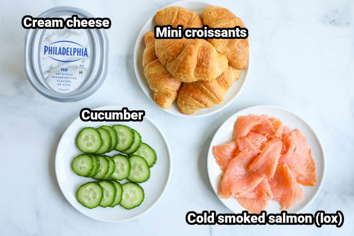 Ingredients for a Smoked Salmon Sandwich: mini croissants, cream cheese, cucumber, and cold smoked salmon.