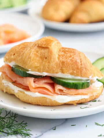 Smoked Salmon Sandwich on a croissant with cream cheese and cucumber.