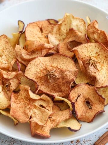 Close up of Crispy Air Fryer Apple Chips in a bowl.