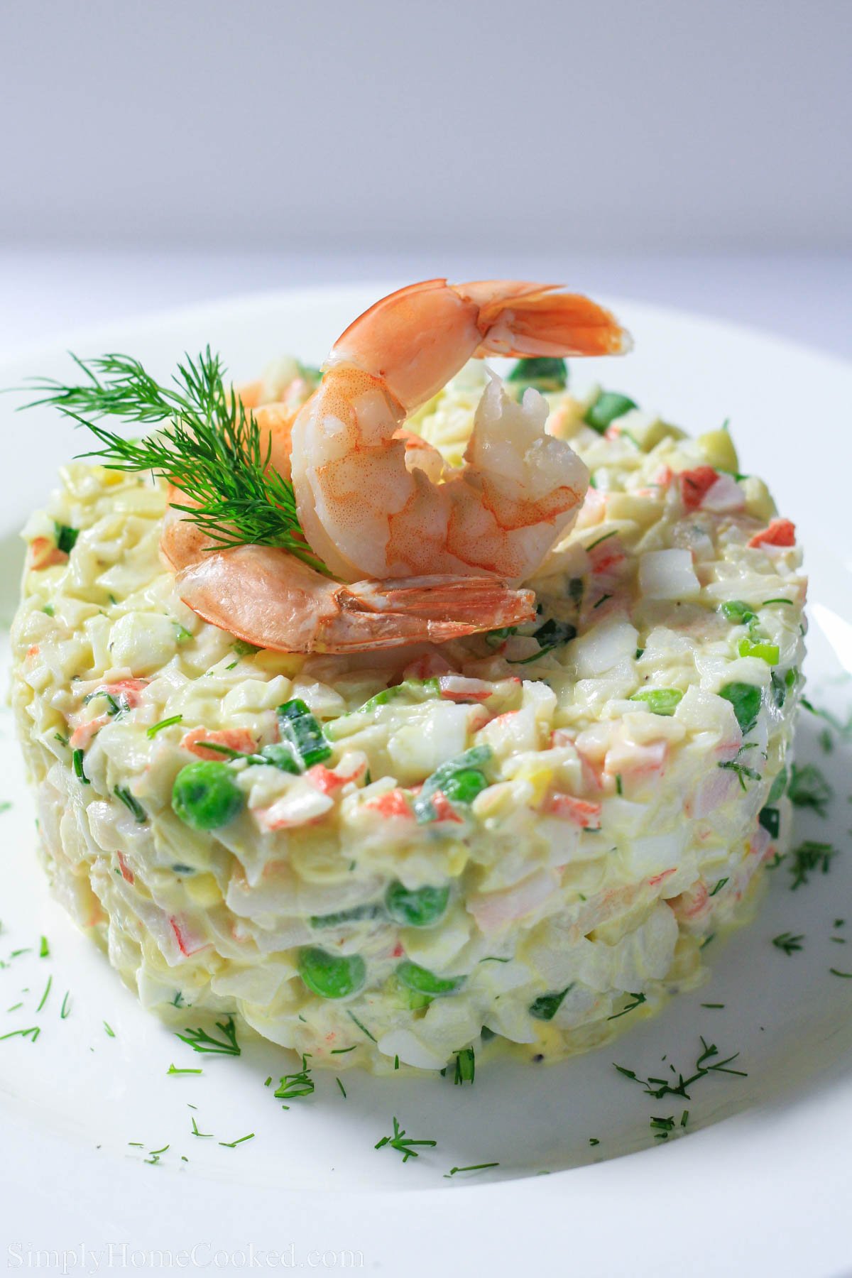 Crab Salad topped with shrimp and dill.
