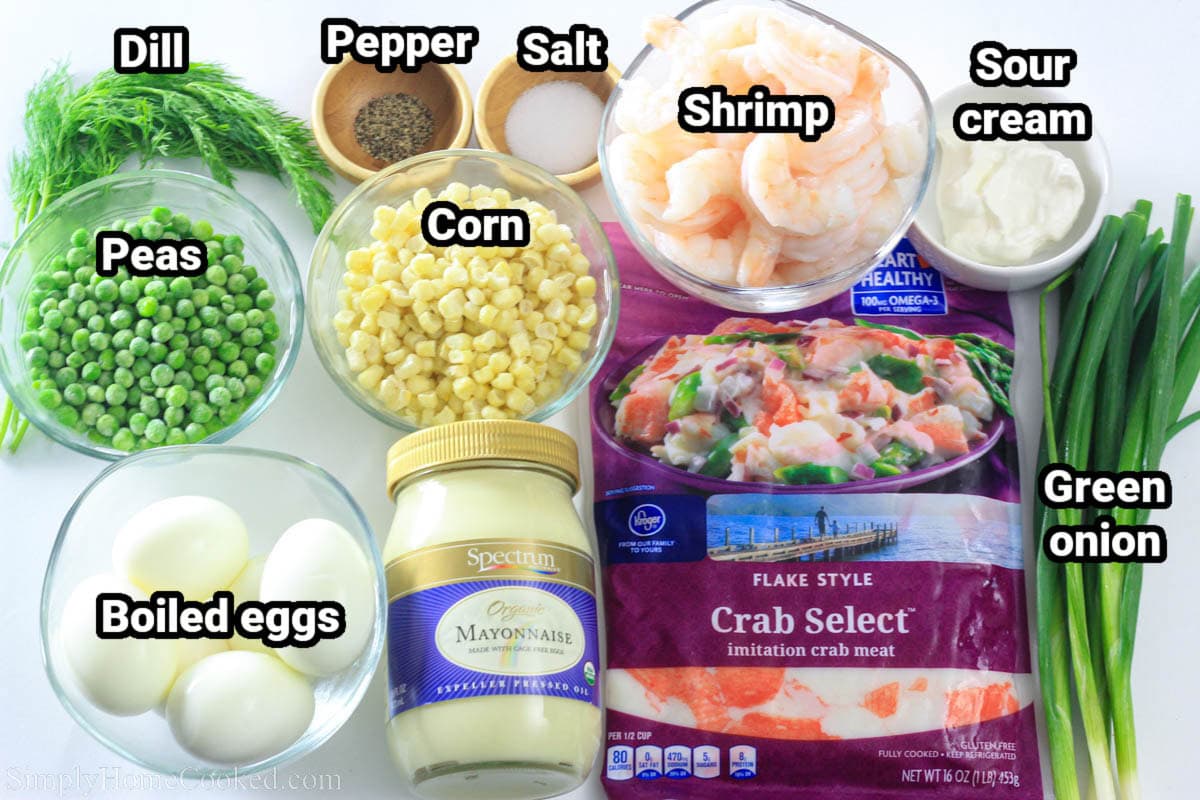 Ingredients for Crab Salad: imitation crab, green onions, mayo, sour cream, shrimp, corn, peas, boiled eggs, dill, salt, and pepper.