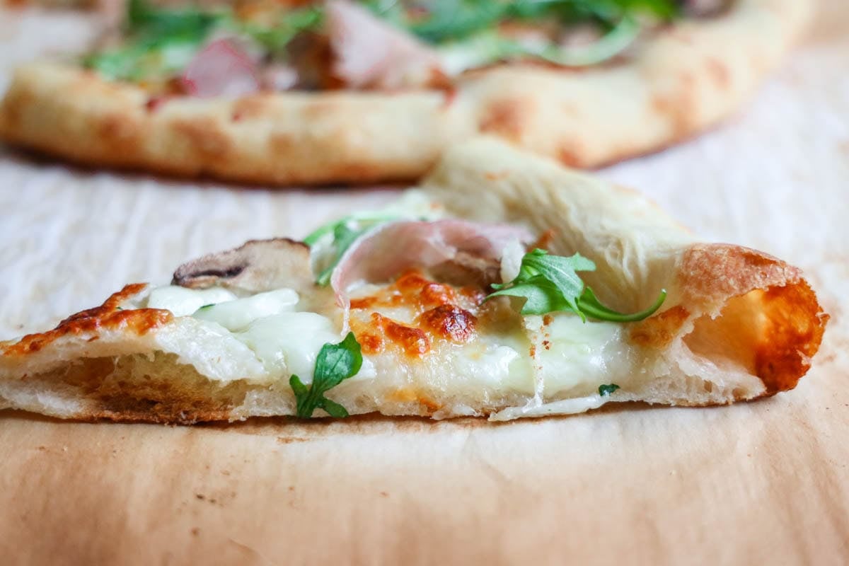 Sourdough Pizza crust with arugula and prosciutto.