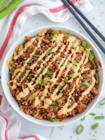 Overhead view of Egg Roll in a Bowl drizzled with spicy mayo.