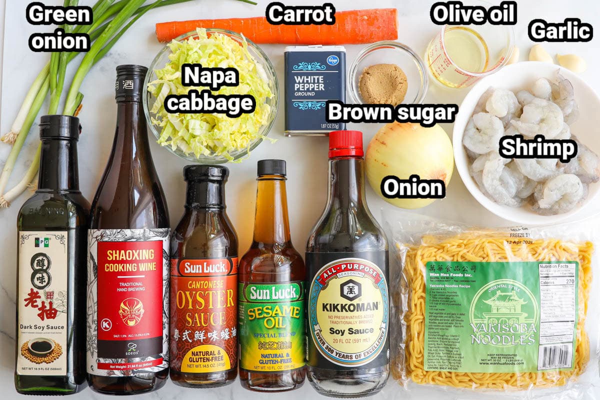 Ingredients for Shrimp Lo Mein: green onion, napa cabbage, carrot, olive oil, garlic, brown sugar, shrimp, onion, white pepper, yakisoba noodles, soy sauce, dark soy sauce, sesame oil, oyster sauce, and cooking wine.