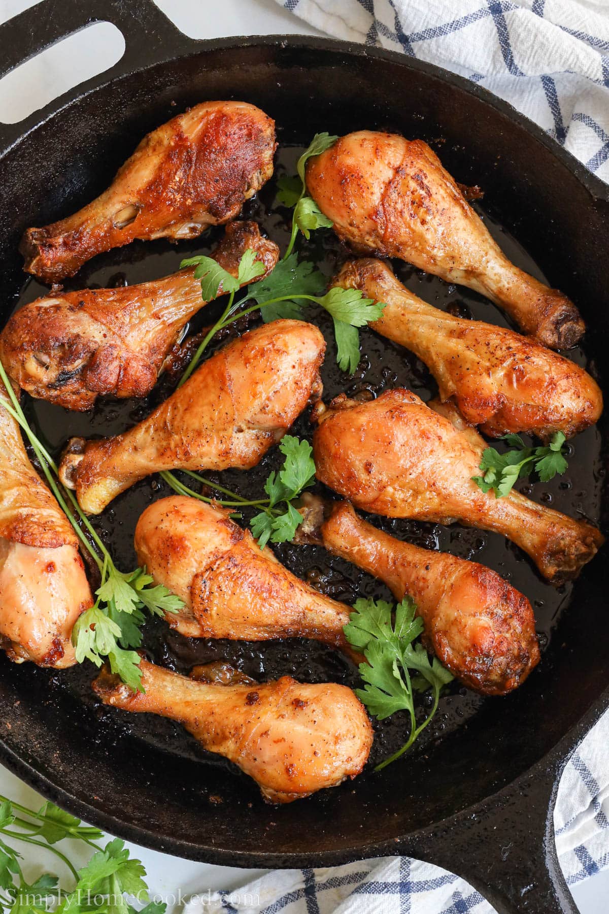 Overhead view of Baked Chicken Drumsticks in a cast iron skillet.