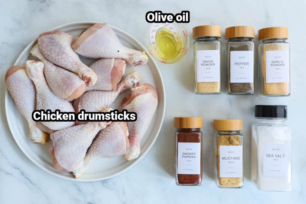 Ingredients for Baked Chicken Drumsticks: chicken drumsticks, olive oil, onion powder, garlic powder, mustard powder, smoked paprika, seas salt, and black pepper.