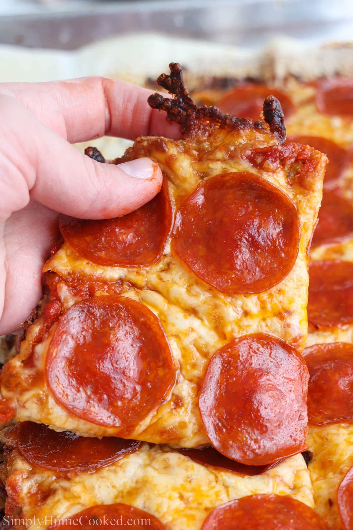 Close up of a slice of Chicken Crust Pizza.